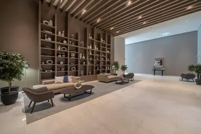 a living room with a couch and chairs and shelves at Boho-Chic Cosy 1BR, minutes to Burj Khalifa in Dubai