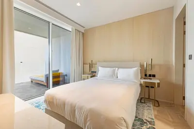 a bedroom with a large white bed and a balcony at FIVE Palm Residence - Platinium Dubai in Dubai