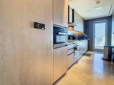 a kitchen with stainless steel appliances and a large window at FIVE Palm Residence - Platinium Dubai in Dubai