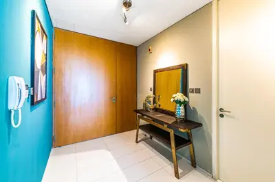 a hallway with a table with a vase of flowers on it at Index Tower by Radiance Vacation Stays 43rd Floor in Dubai