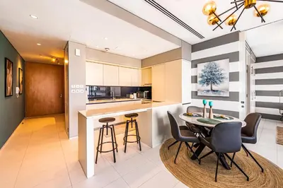a kitchen and dining room with a table and chairs at Index Tower by Radiance Vacation Stays 43rd Floor in Dubai