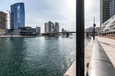 a view of a river in a city with tall buildings at The Smart Concierge - The Vogue in Dubai