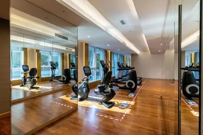 a gym with treadmills and ellipticals in a building at The Smart Concierge - The Vogue in Dubai