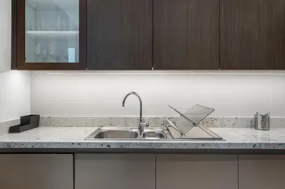 a kitchen with a sink and a counter top at Breathtaking City Views From DT Apt with Terrace in Dubai