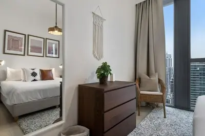 a bedroom with a bed and a large mirror at Breathtaking City Views From DT Apt with Terrace in Dubai
