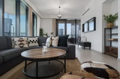 a living room with a couch and a table at Breathtaking City Views From DT Apt with Terrace in Dubai