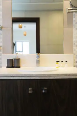 a bathroom with a sink and a mirror at Scenic 2 Bedroom Apartment - Downtown Business Bay in Dubai