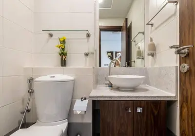 a bathroom with a white toilet and a sink at Scenic 2 Bedroom Apartment - Downtown Business Bay in Dubai