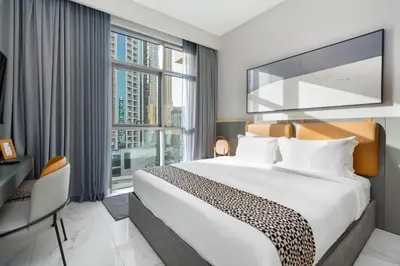 a hotel room with a bed and a large window at Bespoke Holiday Homes - Mag 318 Downtown Dubai in Dubai