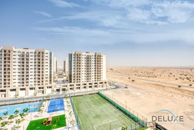 an aerial view of a beach with tall buildings at Chic 1BR in Town Square UNA Dubailand by Deluxe Holiday Homes in Dubai