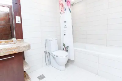 a bathroom with a toilet and a bath tub at Holidays R Us canal view in Dubai
