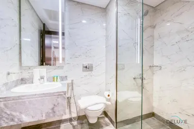 a bathroom with a toilet and a sink and a shower at Snug 1BR at MAG 520 Dubai South by Deluxe Holiday Homes in Dubai