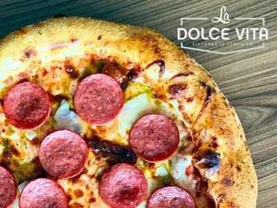 a pepperoni pizza sitting on top of a table at Asma Hotel Al Barsha in Dubai