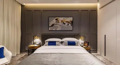 a bedroom with a large bed with blue pillows at Rose Executive Hotel - DWTC in Dubai