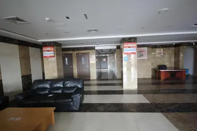 a waiting room with a leather chair and a table at Comfortable Apartments and Studios for Rent in Dubai in Dubai