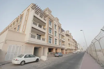 a white car parked in front of a building at Comfortable Apartments and Studios for Rent in Dubai in Dubai