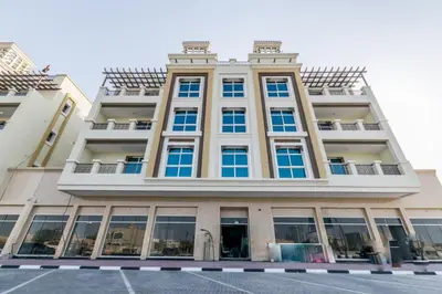 a tall building with blue windows and balconies at Comfortable Apartments and Studios for Rent in Dubai in Dubai