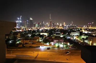 a view of a city at night with lights at Comfortable Apartments and Studios for Rent in Dubai in Dubai
