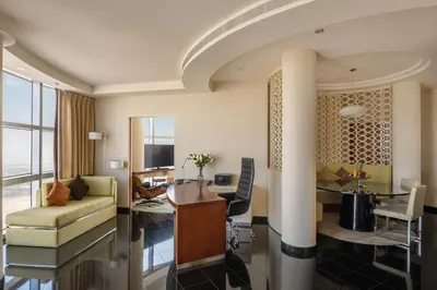 a living room with a couch and a table at Jumeirah Emirates Towers Dubai in Dubai