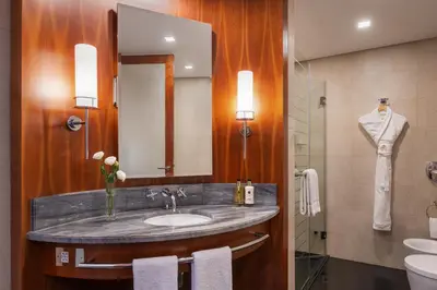 a bathroom with a sink and a mirror at Jumeirah Emirates Towers Dubai in Dubai
