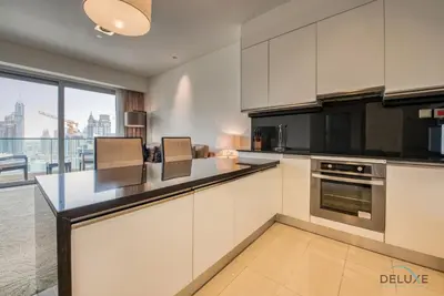 a kitchen with white cabinets and a large window at Exquisite 1BR at The Address Residences Dubai Marina by Deluxe Holiday Homes in Dubai