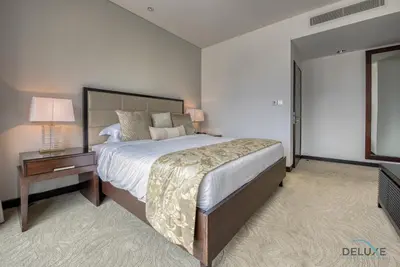 a bedroom with a large bed and a table with a lamp at Exquisite 1BR at The Address Residences Dubai Marina by Deluxe Holiday Homes in Dubai