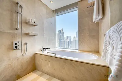 a bathroom with a tub and a window at Exquisite 1BR at The Address Residences Dubai Marina by Deluxe Holiday Homes in Dubai