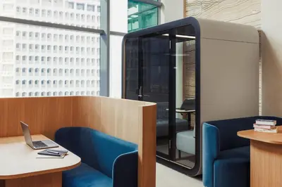 an office with a blue chair and a desk with a laptop at Jumeirah Living World Trade Centre Dubai in Dubai