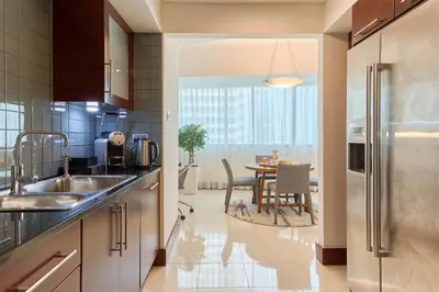 a kitchen with a table and a dining room at Jumeirah Living World Trade Centre Dubai in Dubai