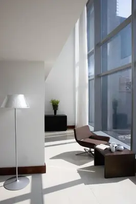 a living room with a chair and a table at Jumeirah Living World Trade Centre Dubai in Dubai