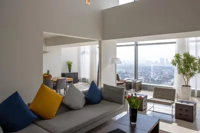 a living room with a couch with colorful pillows at Jumeirah Living World Trade Centre Dubai in Dubai