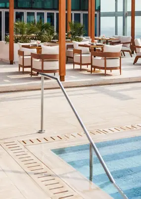 a pool with tables and chairs on a building at Jumeirah Living World Trade Centre Dubai in Dubai