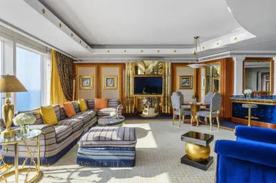 a living room with a couch and a tv at Jumeirah Burj Al Arab Dubai in Dubai