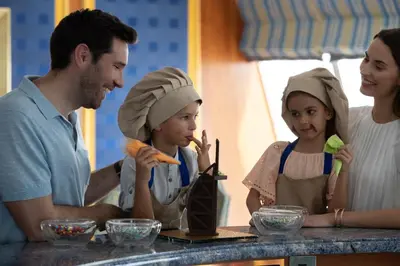 a group of people standing around a table with food at Jumeirah Burj Al Arab Dubai in Dubai