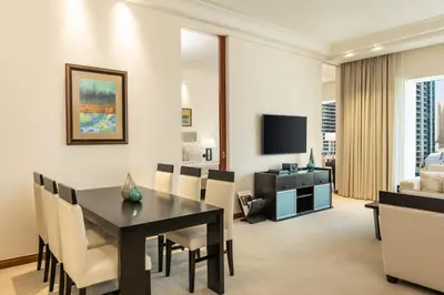 a dining room and living room with a table and chairs at Grosvenor House, a Luxury Collection Hotel, Dubai in Dubai