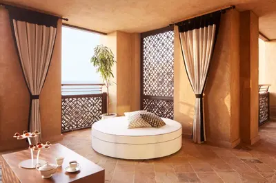 a room with a round bed in a room with windows at Jumeirah Mina Al Salam Dubai in Dubai