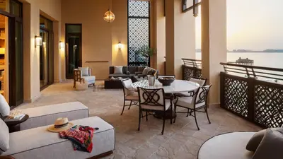 a living room with a table and chairs at Jumeirah Mina Al Salam Dubai in Dubai