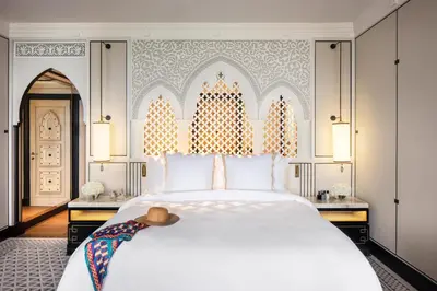 a bedroom with a large white bed in a room at Jumeirah Mina Al Salam Dubai in Dubai