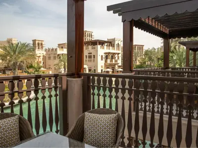 a balcony with a table and chairs and buildings at Jumeirah Dar Al Masyaf Dubai in Dubai