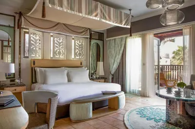 a bedroom with a bed and a living room at Jumeirah Dar Al Masyaf Dubai in Dubai