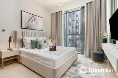 a bedroom with a large white bed and a large window at Dream Inn Apartments- Boulevard Heights in Dubai