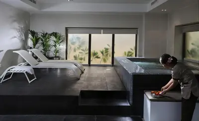 a man standing in a bathroom with a bath tub at Ramada Hotel, Suites and Apartments by Wyndham Dubai JBR in Dubai