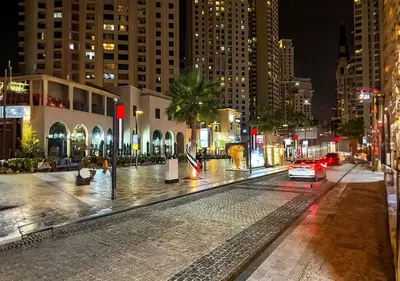 a car driving down a city street at night at Ramada Hotel, Suites and Apartments by Wyndham Dubai JBR in Dubai