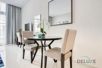 a dining room with a table and chairs at Calm Studio in Damac Celestia A Dubai South by Deluxe Holiday Homes in Dubai