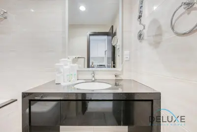 a bathroom with a sink and a mirror at Calm Studio in Damac Celestia A Dubai South by Deluxe Holiday Homes in Dubai