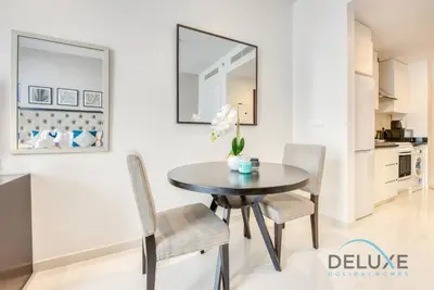 a dining room table and chairs in a kitchen at Calm Studio in Damac Celestia A Dubai South by Deluxe Holiday Homes in Dubai