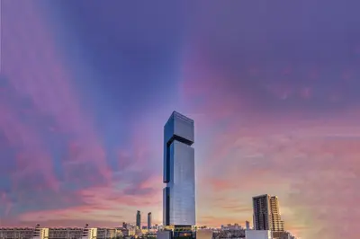 a rendering of a tall building in a city at The First Collection Dubai Jumeirah Village Circle, a Tribute Portfolio Hotel in Dubai