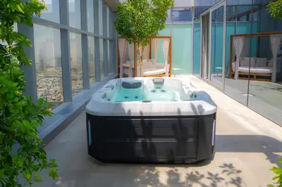 a hot tub on a balcony of a building at The First Collection Dubai Jumeirah Village Circle, a Tribute Portfolio Hotel in Dubai