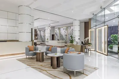 a rendering of a lobby with tables and chairs at Hilton Dubai Jumeirah in Dubai