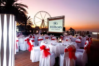 a set of tables with red and white bows at Hilton Dubai Jumeirah in Dubai